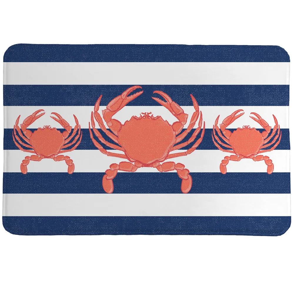 Crab Stripe Memory Foam Rug showcases a classic navy blue nautical stripes that serves as the background to three coral-colored crabs.