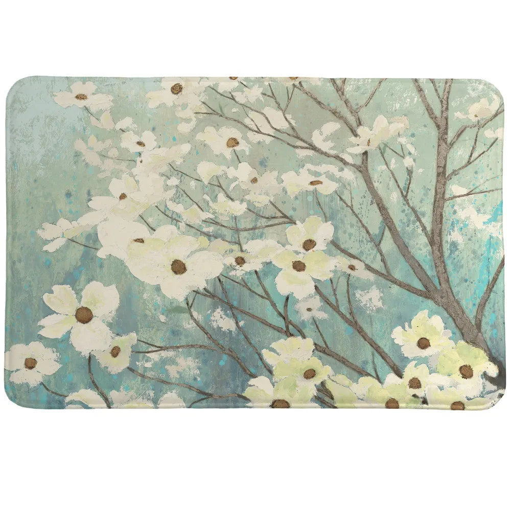 Dogwood Blossom Memory Foam Rug features white dogwoods blossoming from branches set behind a vibrant sky.
