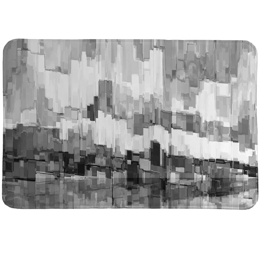 Grey Glacier Memory Foam Rug portrays an abstract image of crystal rising out of the cold sea in greyscale.