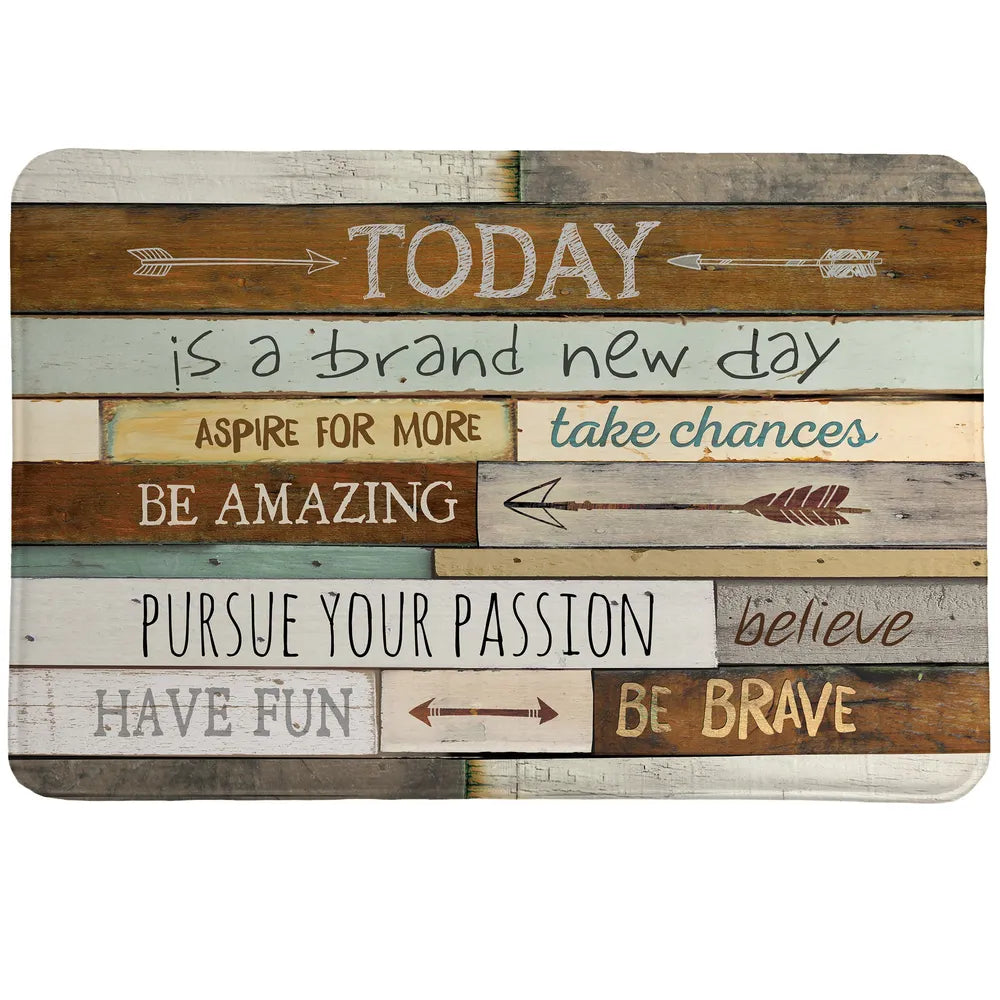 Inspiring Mantra Memory Foam Rug features positive sayings with a salvaged wood backdrop accompanied by various arrows.