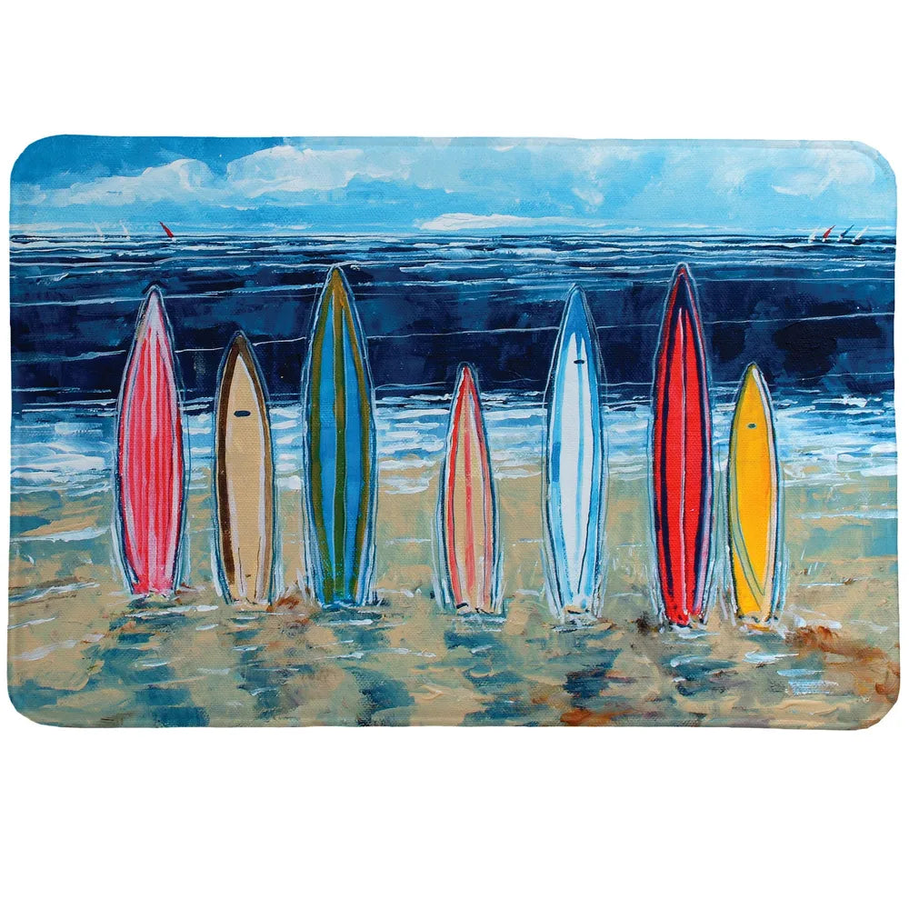 Surfboards Memory Foam Rug shows surfboards resting in the sad against an ocean backdrop. 